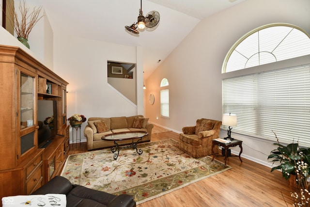 2805 Rylee Ct, Greenwood, IN 46143 - living area featuring lofted ceiling, healthy amount of natural light, wood finished floors, and baseboards