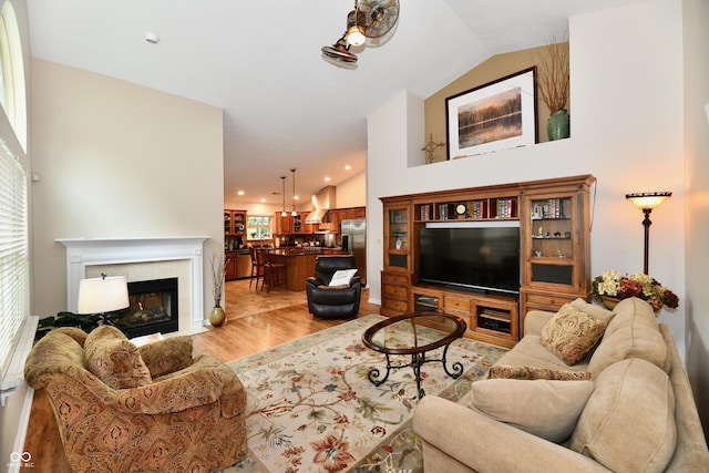 2805 Rylee Ct, Greenwood, IN 46143 - living area with lofted ceiling, light wood-style floors, healthy amount of natural light, a tiled fireplace, and recessed lighting