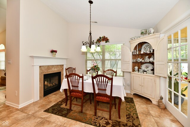2805 Rylee Ct, Greenwood, IN 46143 - dining room featuring lofted ceiling, a chandelier, plenty of natural light, a fireplace, and light tile patterned flooring