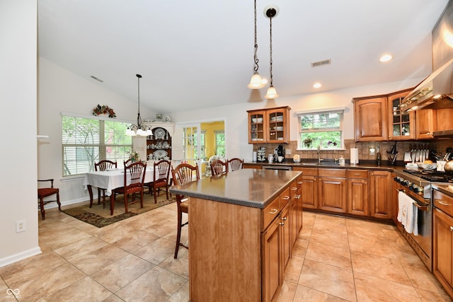 2805 Rylee Ct, Greenwood, IN 46143 - kitchen with brown cabinetry, a breakfast bar area, backsplash, stainless steel appliances, and light tile patterned flooring