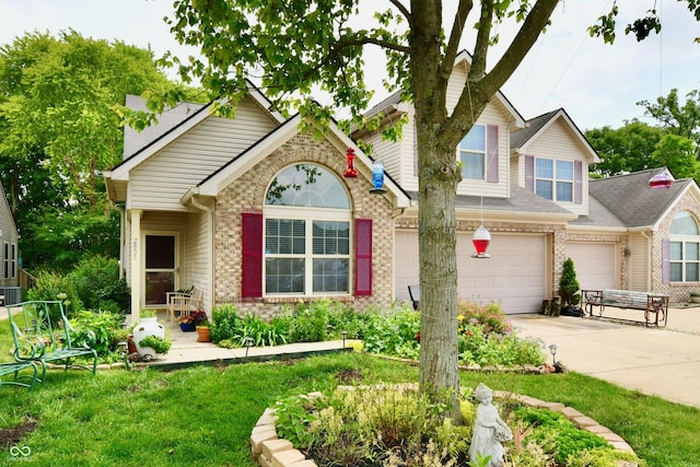 2805 Rylee Ct, Greenwood, IN 46143 - view of front of house featuring concrete driveway, brick siding, an attached garage, and a front lawn