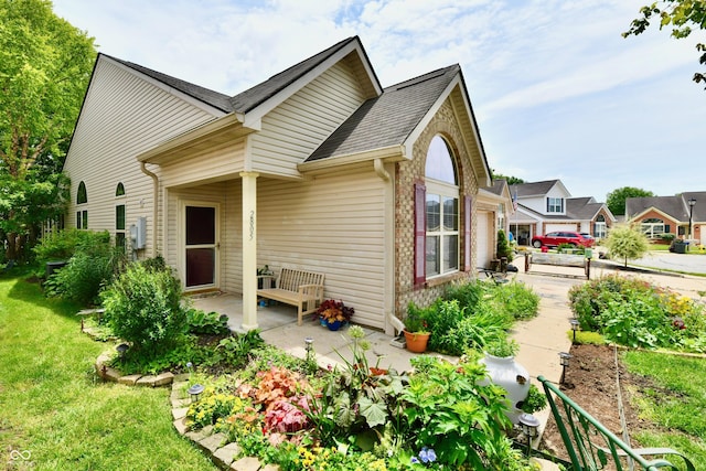 2805 Rylee Ct, Greenwood, IN 46143 - view of front of home featuring a patio, a front lawn, a shingled roof, and brick siding