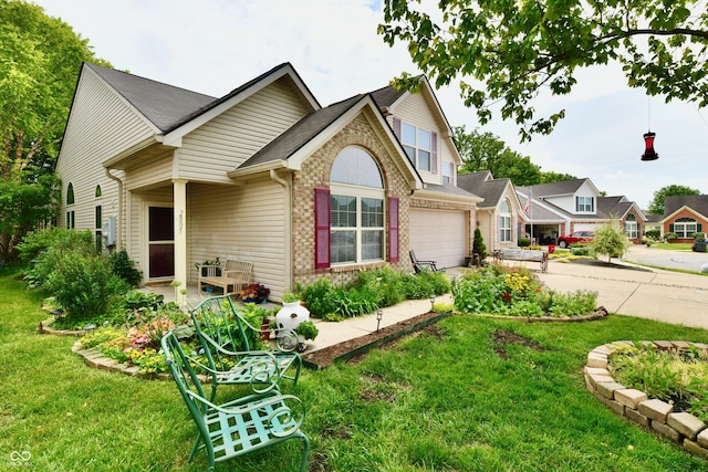 2805 Rylee Ct, Greenwood, IN 46143 - view of front of house with concrete driveway, a front lawn, brick siding, and a garage