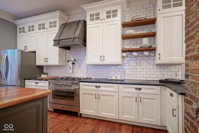 1512 Bellefontaine St, Indianapolis, IN 46202 - kitchen with stainless steel appliances, custom exhaust hood, open shelves, dark wood-type flooring, and tasteful backsplash