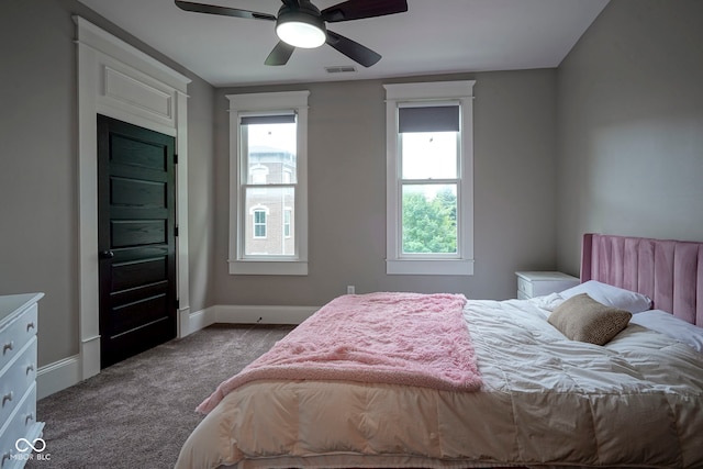 1512 Bellefontaine St, Indianapolis, IN 46202 - carpeted bedroom featuring multiple windows, baseboards, and ceiling fan