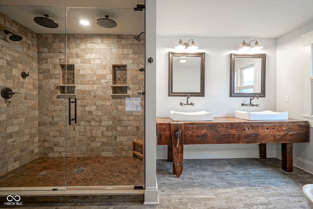 1512 Bellefontaine St, Indianapolis, IN 46202 - full bathroom featuring a shower stall, double vanity, baseboards, and wood finished floors