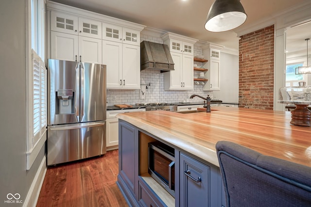 1512 Bellefontaine St, Indianapolis, IN 46202 - kitchen with stainless steel appliances, premium range hood, backsplash, ornamental molding, and butcher block countertops