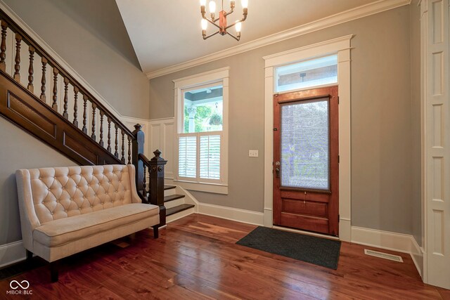 1512 Bellefontaine St, Indianapolis, IN 46202 - entryway with stairs, ornamental molding, a chandelier, wood finished floors, and baseboards
