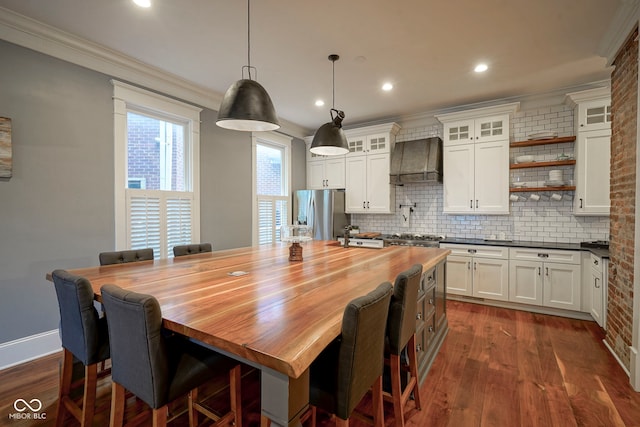 1512 Bellefontaine St, Indianapolis, IN 46202 - kitchen with stainless steel refrigerator with ice dispenser, premium range hood, decorative backsplash, ornamental molding, and dark wood-style flooring