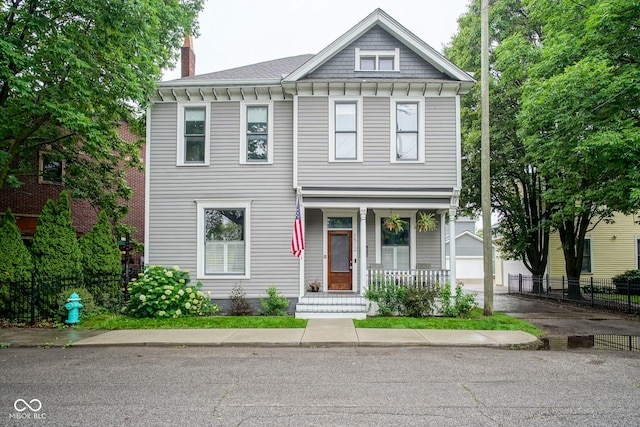 1512 Bellefontaine St, Indianapolis, IN 46202 - view of front of property featuring a porch, an outbuilding, and a chimney