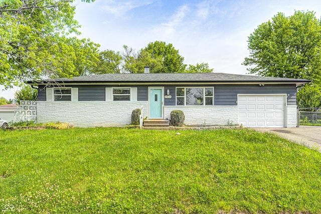 3414 Ferncliff Ave, Indianapolis, IN 46227 - ranch-style home with entry steps, an attached garage, driveway, and stone siding