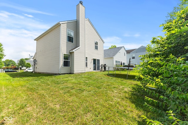 9125 Timpani Way, Indianapolis, IN 46231 - back of property with a chimney and a lawn