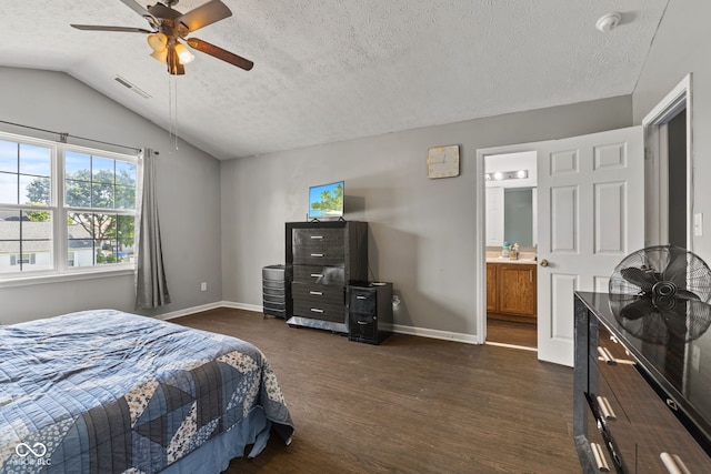 9125 Timpani Way, Indianapolis, IN 46231 - bedroom with dark wood-style floors, vaulted ceiling, a textured ceiling, connected bathroom, and a ceiling fan