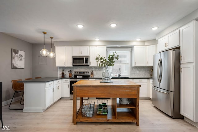 22 N Bolton Ave, Indianapolis, IN 46219 - kitchen featuring stainless steel appliances, a peninsula, open shelves, white cabinets, and backsplash