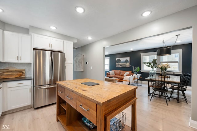 22 N Bolton Ave, Indianapolis, IN 46219 - kitchen featuring freestanding refrigerator, light wood-style flooring, white cabinets, wood counters, and recessed lighting