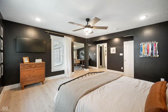 22 N Bolton Ave, Indianapolis, IN 46219 - bedroom with baseboards, wood finished floors, and ceiling fan