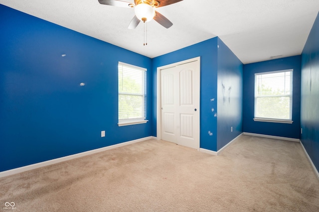 1412 Huntzinger Blvd, Pendleton, IN 46064 - unfurnished bedroom with carpet floors, baseboards, a closet, and ceiling fan