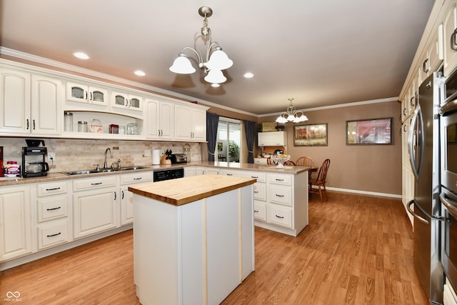1910 Ivy Dr, Anderson, IN 46011 - kitchen featuring a chandelier, wooden counters, a peninsula, a sink, and ornamental molding