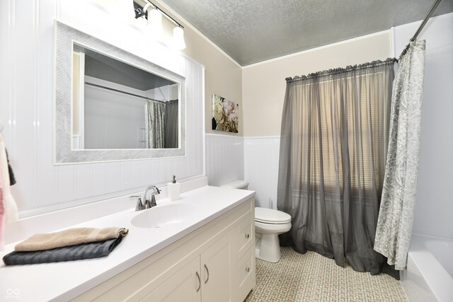1910 Ivy Dr, Anderson, IN 46011 - bathroom with toilet, vanity, a textured ceiling, wainscoting, and tile patterned flooring