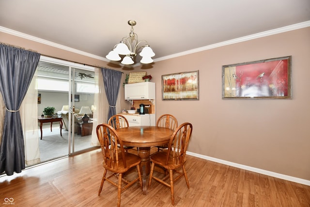 1910 Ivy Dr, Anderson, IN 46011 - dining room featuring light wood finished floors, crown molding, a chandelier, and baseboards