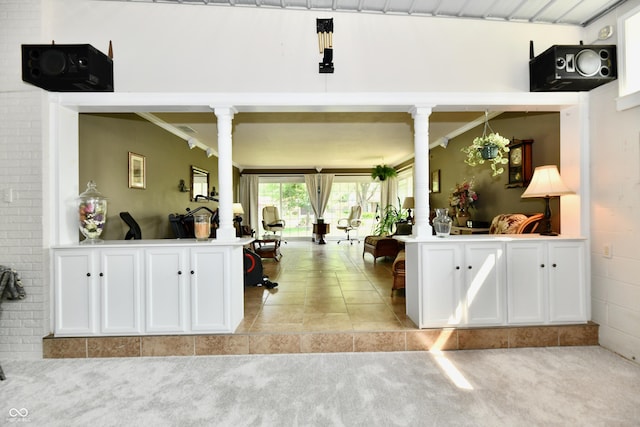 1910 Ivy Dr, Anderson, IN 46011 - kitchen with light colored carpet, white cabinetry, light countertops, ornate columns, and open floor plan