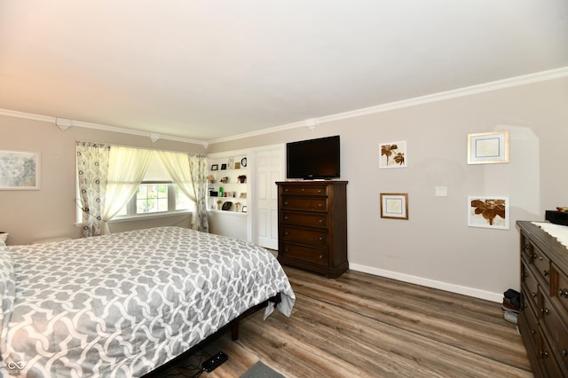 1910 Ivy Dr, Anderson, IN 46011 - bedroom featuring crown molding, baseboards, and wood finished floors