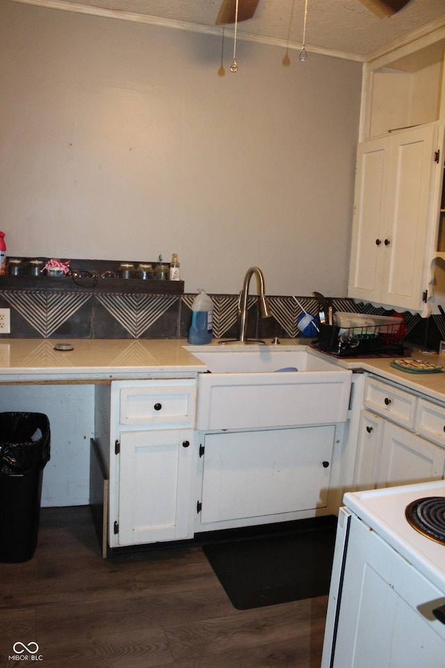 2232 Fairview St, Anderson, IN 46016 - kitchen with white cabinets, dark wood-type flooring, a sink, light countertops, and white electric range oven