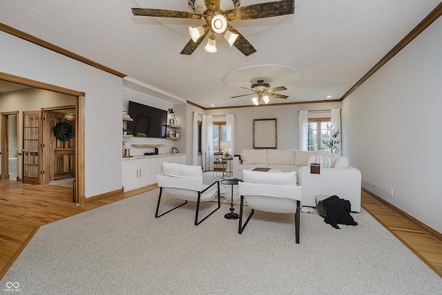 815 Copperfield Ln, Danville, IN 46122 - living area with ornamental molding, a ceiling fan, and light wood-style flooring