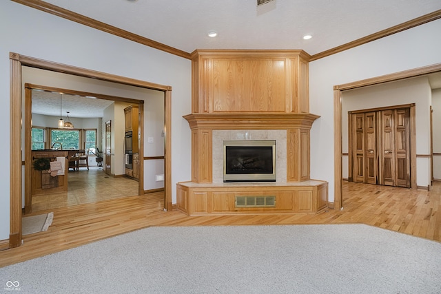 815 Copperfield Ln, Danville, IN 46122 - unfurnished living room with a high end fireplace, light wood-style flooring, ornamental molding, and recessed lighting