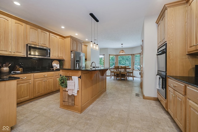 815 Copperfield Ln, Danville, IN 46122 - kitchen with stainless steel appliances, decorative backsplash, recessed lighting, hanging light fixtures, and a kitchen island with sink
