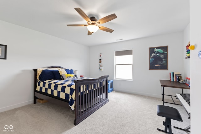 carpeted bedroom featuring baseboards and ceiling fan