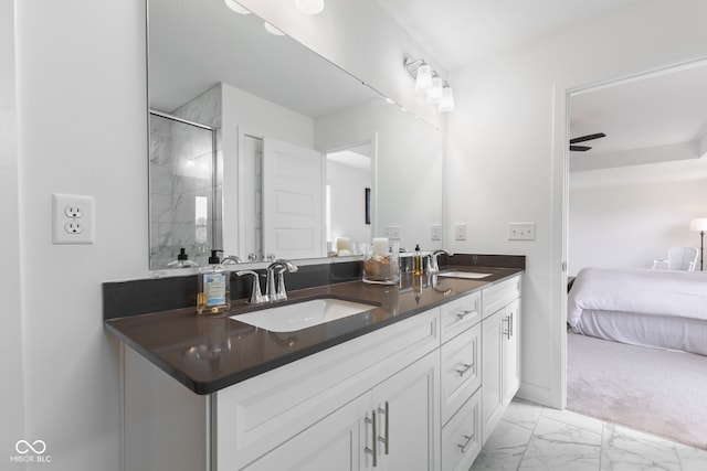 bathroom featuring double vanity, marble finish flooring, a shower, and connected bathroom