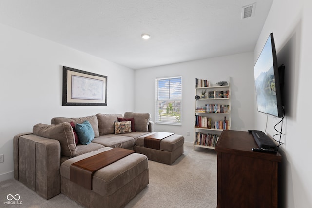 living room featuring light carpet and baseboards
