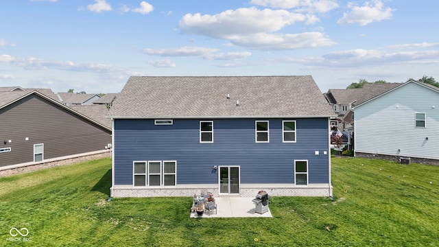 rear view of property featuring a patio area, a yard, and brick siding