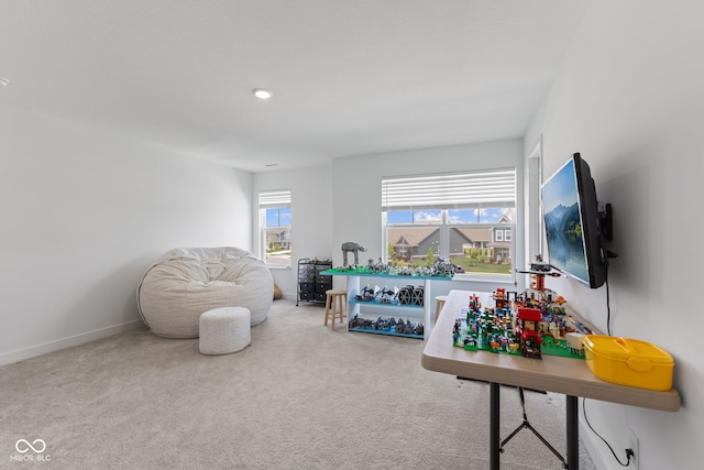 carpeted living area with baseboards and recessed lighting