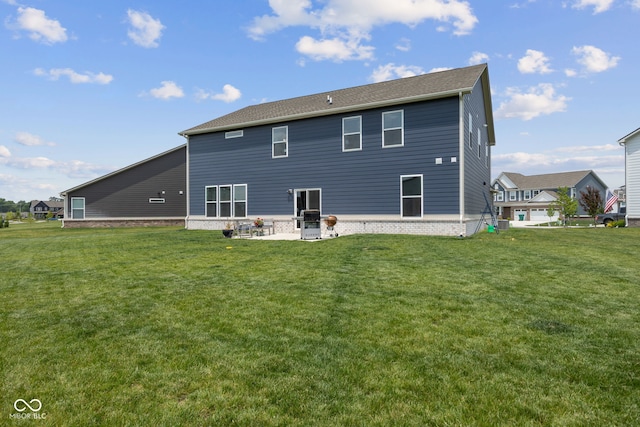 rear view of house featuring a lawn and a patio area