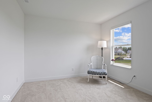unfurnished room featuring carpet floors and baseboards
