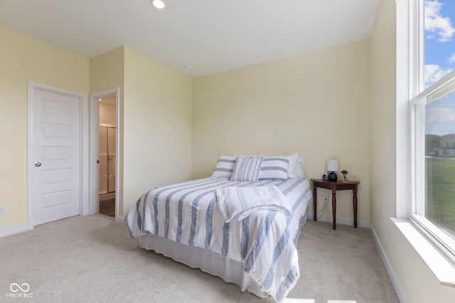 carpeted bedroom with multiple windows and baseboards
