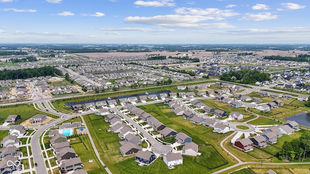 aerial view of property's location featuring nearby suburban area and a nearby body of water