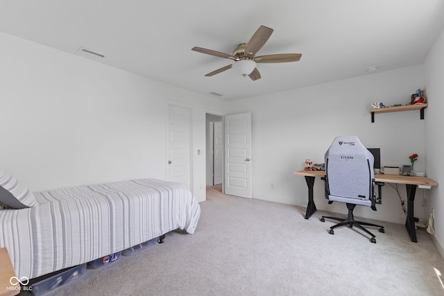 carpeted bedroom with a ceiling fan and baseboards
