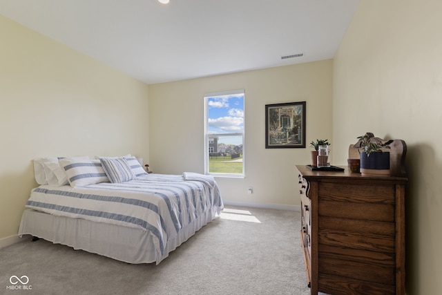 bedroom with baseboards and light carpet