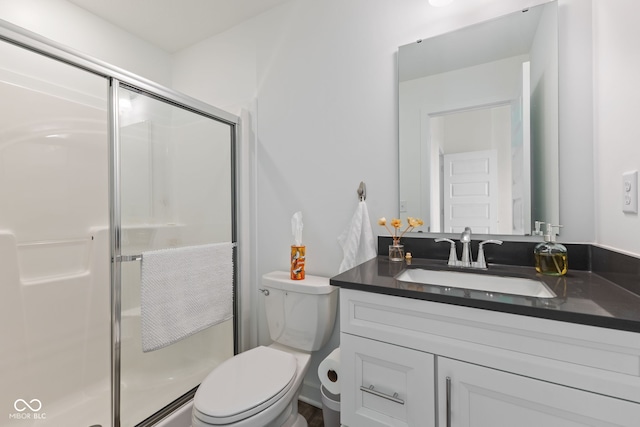 full bath with vanity, a stall shower, and toilet