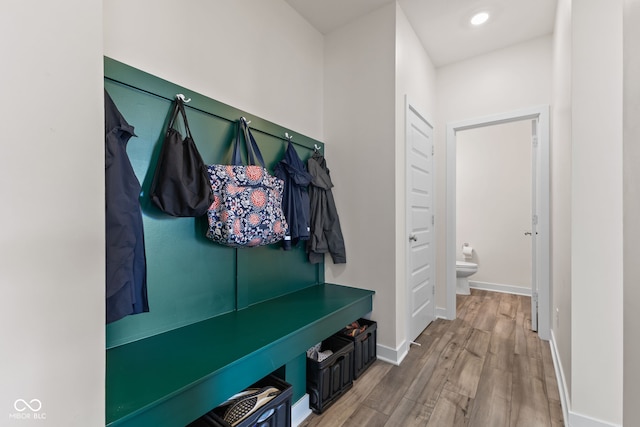 mudroom featuring wood finished floors and baseboards