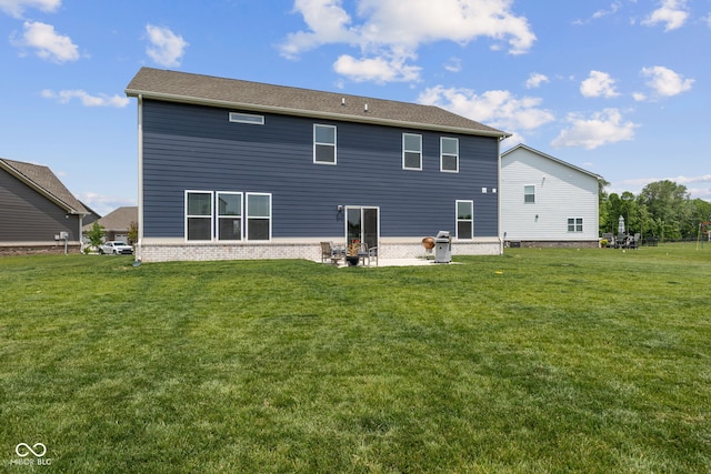 rear view of property featuring a yard and a patio area