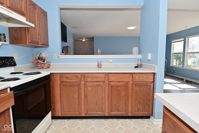 9237 Ogden Dunes Ct, Camby, IN 46113 - kitchen featuring white range with electric stovetop, under cabinet range hood, light countertops, and brown cabinetry
