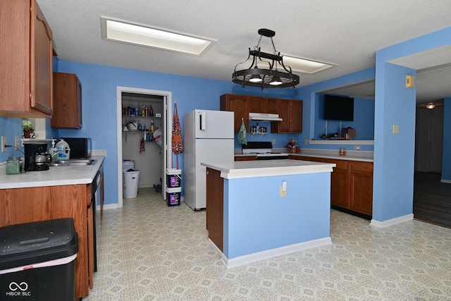 9237 Ogden Dunes Ct, Camby, IN 46113 - kitchen with freestanding refrigerator, under cabinet range hood, light countertops, and brown cabinets