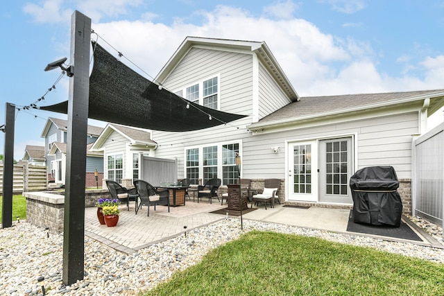 15097 Thoroughbred Dr, Fishers, IN 46040 - rear view of property featuring a fire pit, a patio, brick siding, and a shingled roof