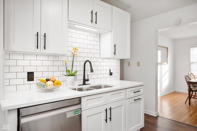 6640 E Washington St, Indianapolis, IN 46219 - kitchen featuring stainless steel dishwasher, a sink, backsplash, and light countertops