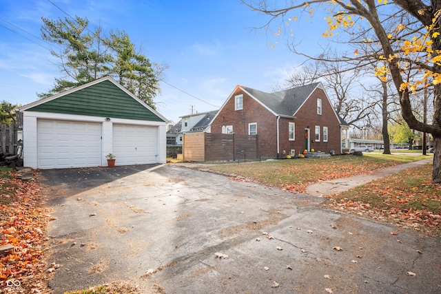 6640 E Washington St, Indianapolis, IN 46219 - view of side of home with brick siding, a garage, and an outbuilding