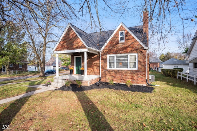 6640 E Washington St, Indianapolis, IN 46219 - view of front of home featuring brick siding, a chimney, covered porch, and central air condition unit